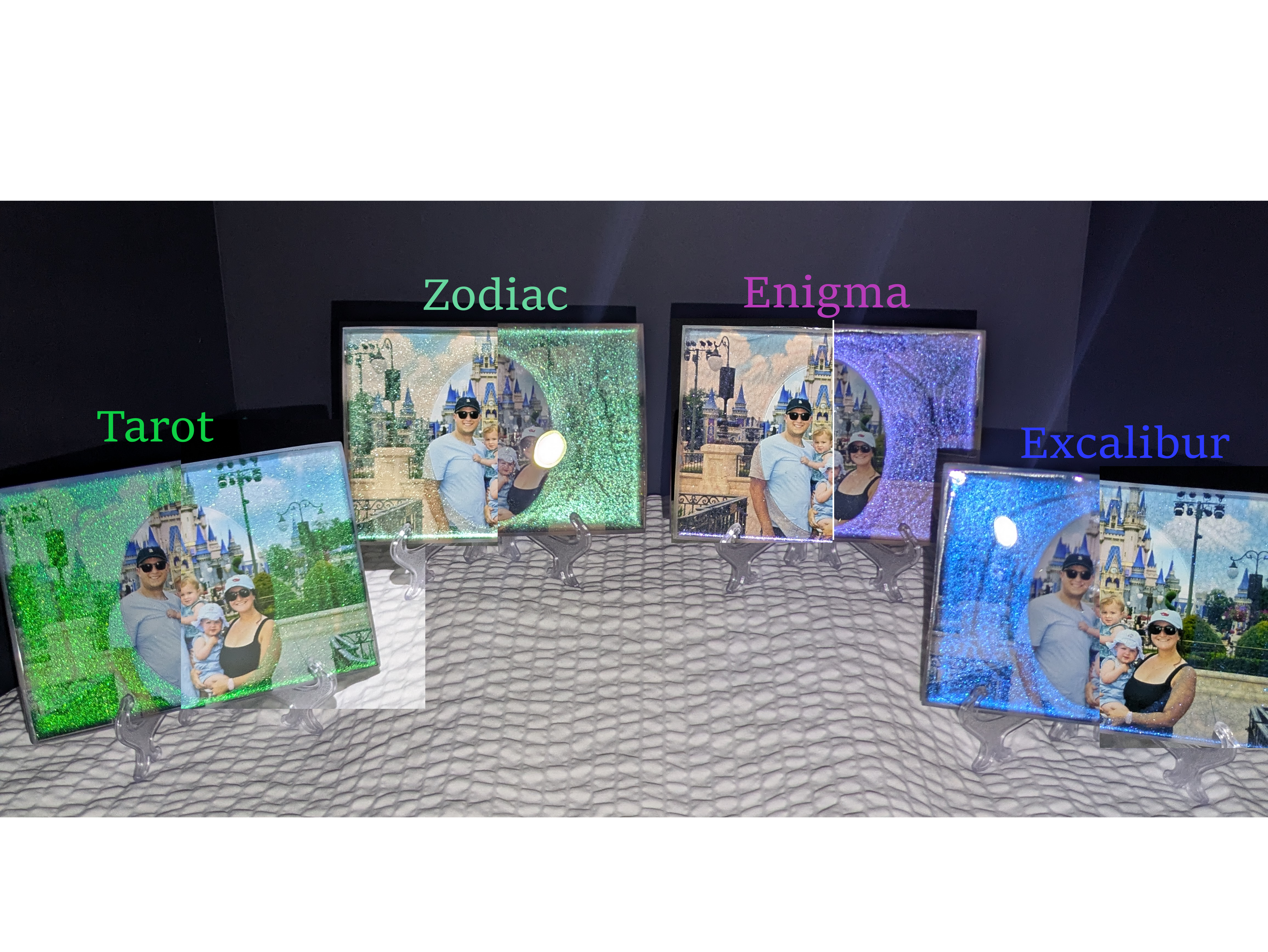 Flat lay of four custom epoxy photo tiles named Tarot, Zodiac, Enigma, and Excalibur, featuring a couple at a theme park, showing off green and blue glitter styles