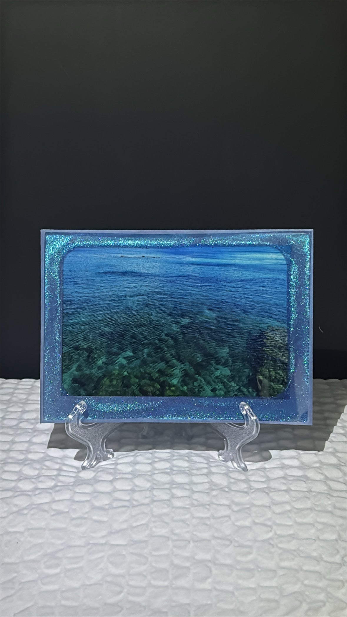 Custom glittery blue epoxy framed photo of the Mediterranean Sea.