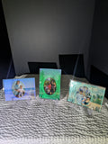 Group of three custom glittery epoxy photo frames in blue and green, displaying various family portraits